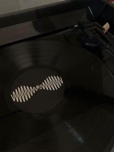 an old record player with its turntable turned on and the vinyl is being taken out