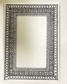 a mirror sitting on top of a white wall