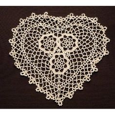 a white doily is shown on a black surface