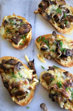 several pieces of bread with mushrooms and cheese on them