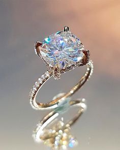 an engagement ring with a cushion cut diamond