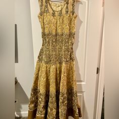 So Pretty Gold And Tan Sleeveless Dress. Sequin And Foil Finish In Hem. Paired With Matching Duppata And Pants. Worn Once Size Xl Waist: 37 In Length: 56 In Beige Dresses With Traditional Drape For Festivals, Beige Dress With Pallu In Traditional Drape, Bollywood Style Cream Floor-length Dress, Anarkali Cream Dress For Festivals, Beige Dress With Pallu, Cream Floor-length Dress For Festivals, Traditional Sleeveless Cutdana Dress, Cream Bollywood Floor-length Dress, Cream Floor-length Bollywood Dress