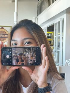 a woman taking a selfie with her cell phone