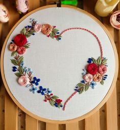 a heart shaped embroidery on a wooden table