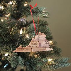 an ornament hanging from the top of a christmas tree