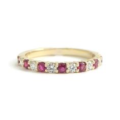 Ruby Diamond Ring Gemstone Wedding Band 14K Yellow Gold, .50 CTW This is a beautiful wedding band, anniversary ring or statement ring! Don't hesitate to ask any questions! Gemstones: 8 round rubies, .28 ctw Diamonds: 7 round brilliant cuts .22 ctw, G, SI1 Metal: 14K yellow gold Weight: 1.85 grams Stamped: 14K Size: 6.25 (can be sized for a small fee) Width: 2.2 mm top of ring Stock: W2098 Gemstone Wedding Band, Ruby Diamond Ring, Beautiful Wedding Bands, Gemstone Wedding, Ruby Diamond Rings, Ruby Diamond, Womens Wedding Bands, Yellow Gold Ring, Anniversary Bands