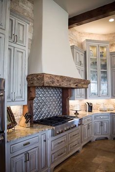 a kitchen with an oven, stove and cabinets in it's center island area