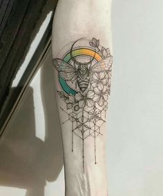 a woman's leg with a tattoo on it and a bee in the middle