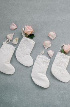 three pairs of white socks with pink roses on them