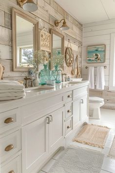 a white bathroom with two sinks and mirrors on the wall next to it is decorated in wood planks