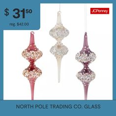 three glass ornaments hanging from strings with price tag for $ 31 50 reg $ 42 00