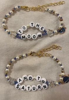 two bracelets that say to the moon and i love you at the same time