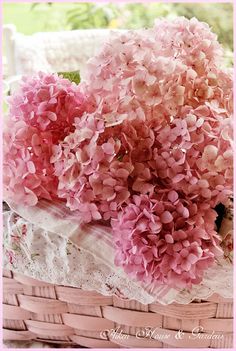 pink flowers in a basket on a table