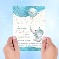 someone holding up a baby shower card with an elephant on it