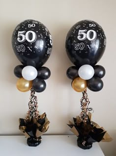 two black and white balloons with numbers on them