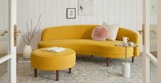 a yellow couch and ottoman in a living room