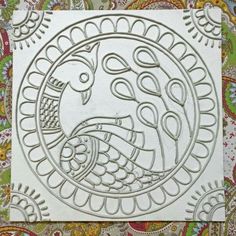 an intricately designed piece of paper with a bird on it's face in the middle