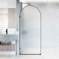 a bathroom with a glass shower door next to a sink