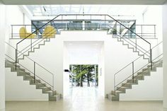 an open staircase leading up to the second floor in a modern house with white walls and floors