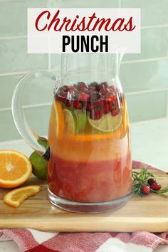 a pitcher filled with punch sitting on top of a cutting board