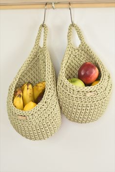 two baskets with handles hold fruit in them