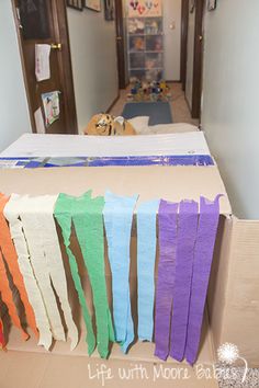 an empty room with several pieces of cardboard taped to the wall and on the floor