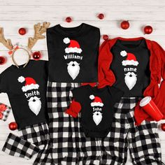 three matching christmas pajamas with santa hats and beards on them, one is black and the other is red