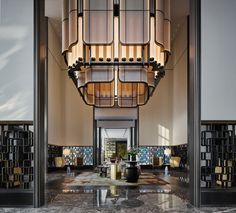 an elegant lobby with chandelier and marble flooring