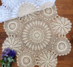 crocheted doily and flowers on the floor