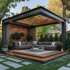 an outdoor living area with couches, tables and potted plants on the ground