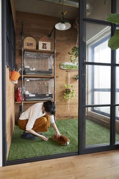 a woman kneeling down on top of a green floor