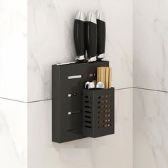 a wall mounted knife holder with knives and toothbrushes in it on a marble background