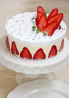 there is a cake with strawberries on it