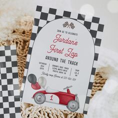 a red and white race car themed birthday party with checkered tablecloth, napkins, and place cards