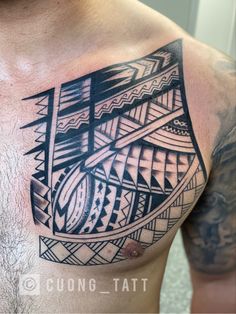 a man's chest with an abstract tattoo design on it