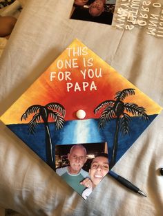 a graduation cap with an image of two men on it and the words, this one is for you papa