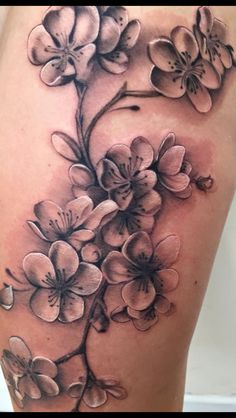 a woman's thigh with flowers on it