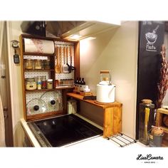 a kitchen with a stove top oven sitting next to a wall mounted chalk board and spice rack