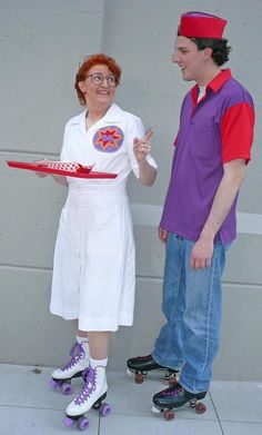 a man and woman dressed in costume standing next to each other on roller skates