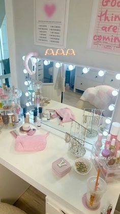 a vanity with lights and makeup products on it