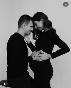 a pregnant couple standing next to each other