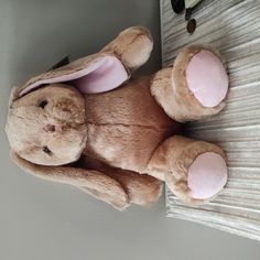 a stuffed animal bunny laying on the floor