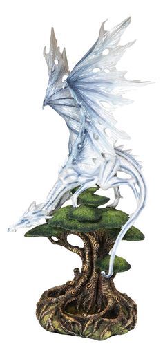 a white dragon statue sitting on top of a green tree stump in front of a white background