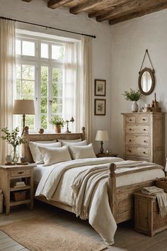 a bed sitting in a bedroom next to a window with white sheets and pillows on top of it