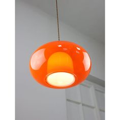 an orange light hanging from a ceiling in a room