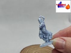 a miniature figurine is being held up to show it's size and shape