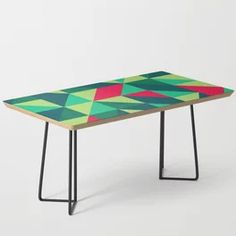 a colorful table with black metal legs and a design on the top that matches it