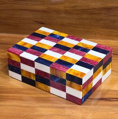 a colorful box sitting on top of a wooden floor