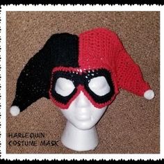 a crocheted hat with a red and black mask