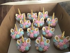 cupcakes in a box with unicorn decorations